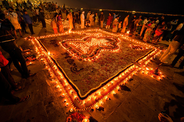 Indian Hindu devotees light Lamps while praying to God on the eve of Dev Deepavali. Dev Deepavali, also known as Diwali of the Gods, is a festival celebrated on Karthik Purnima, which falls 15 days after Diwali. Dev Deepavali is the biggest Light Festival in India, where devotees decorate the river bank of the Ganges with millions of Lamps as part of the festival.