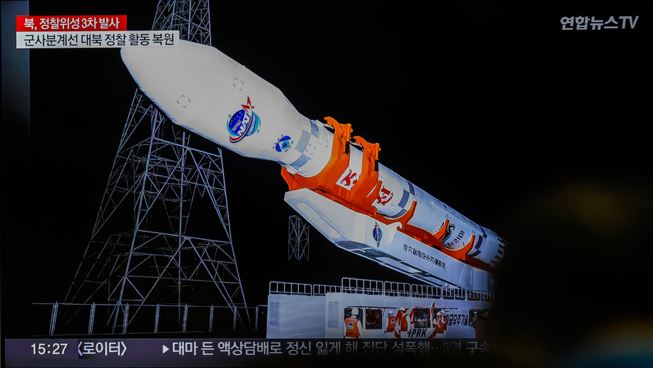 A TV news screen at Seoul's Yongsan Railway Station shows a report that North Korea's reconnaissance satellite, its third attempted launch this year, has entered orbit. North Korea successfully placed a reconnaissance satellite into orbit on November 21 and said it would launch several more satellites 