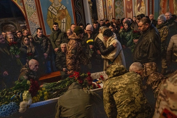 Relatives and friends mourn in front of the coffin of Ukrainian soldier Serhiy Pavlichenko, who died in combat in the Zaporizhzhia region in Russia's continued invasion of Ukraine, at his funeral at St. Michael's Cathedral in Kyiv. Since Russia began its full-scale invasion of Ukraine on Feb. 24, 2022, tens of thousands of Ukrainian and Russian servicemen have been killed.