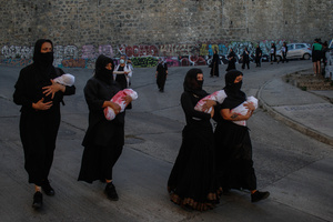 Female protesters dummy babies wrapped in fake blood-stained clothes during the demonstration. Protesters participate in a rally in the city of Valparaiso in Chile to mark the International Day of Solidarity with the Palestinian People, condemning Israel’s war on Gaza and calling for a permanent ceasefire. This day is observed annually on November 29 to remember Resolution 181, when the UN decided in 1947 to divide Palestine into two separate Jewish and Arab states.