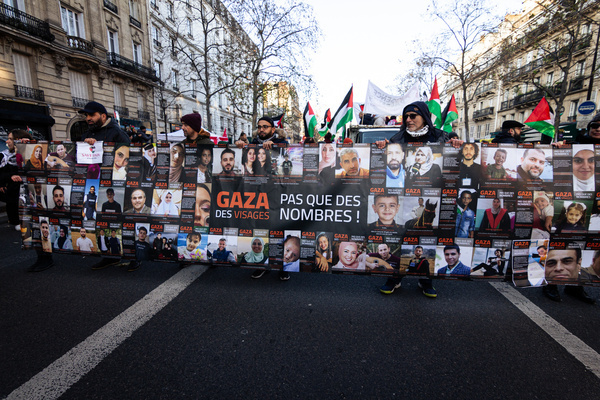 Protesters hold a huge banner with pictures of Palestinian victims of Israeli's attacks during the demonstration for peace in Gaza. In Paris, several left-wing organizations and La France Insoumise political party came together to call for an immediate ceasefire by the Israeli state and accused French President Emmanuel Macron of being complicit in the massacres committed in Gaza. The demonstration began at Place de Republique and ended at Place Bastille.