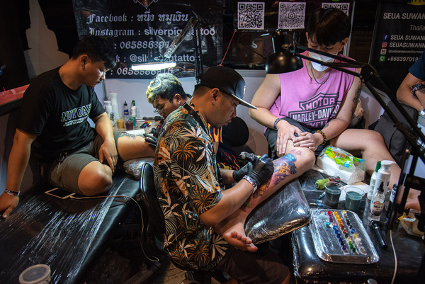 Tattoo artists make tattoos for participants during the Land of Ink Bangkok Tattoo Convention 2023 at ChangChui Creative Park in Bangkok. Hundreds of national and international professional tattoo artists and enthusiasts are participating in the Land of Ink Bangkok Tattoo Convention 2023 to showcase their design skills in a tattoo contest.