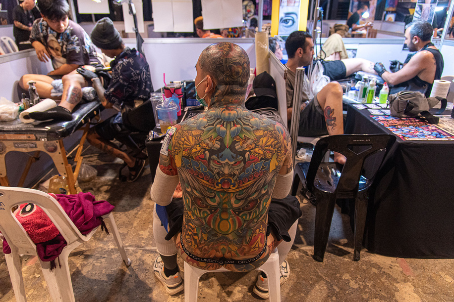A contestant prepares to present his tattoo during the the Land of Ink Bangkok Tattoo Convention 2023 at ChangChui Creative Park in Bangkok. Hundreds of national and international professional tattoo artists and enthusiasts are participating in the Land of Ink Bangkok Tattoo Convention 2023 to showcase their design skills in a tattoo contest.