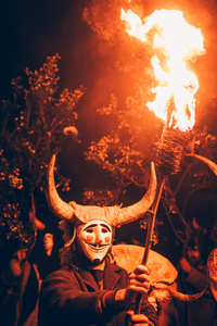The Felos (carnival revellers of Maceda) seen wearing a wooden mask and horns while holding a burning torch during the "Baixada da Marela" parade. "At Entrudo (Carnival), in the village of Maceda (Galicia - northern Spain) the villagers dress up as Felos and during the day they parade through the neighboring villages, during the night they do the "Baixada da Marela", they change clothes and wear horns and animal skins and parade with carts through the streets of Maceda, carrying torches, thorny snot and throwing flour at the visitors!".