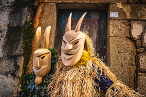 A couple dressed as Careto pose for a photo during the carnival. In Lazarim, northern Portugal, the carnival is celebrated with a tradition known as Entrudo. During this festivity, masks of devils and demons, intricately carved in wood by the village's craftsmen, are prominently featured. The carnival parade through the streets showcases these masks, portraying ancestral scenes of Portuguese culture.