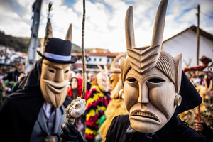 Caretos pose for a photo during the Lazarim carnival. In Lazarim, northern Portugal, the carnival is celebrated with a tradition known as Entrudo. During this festivity, masks of devils and demons, intricately carved in wood by the village's craftsmen, are prominently featured. The carnival parade through the streets showcases these masks, portraying ancestral scenes of Portuguese culture.