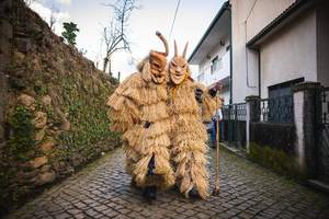 Caretos parade through the streets of Lazarim during carnival. In Lazarim, northern Portugal, the carnival is celebrated with a tradition known as Entrudo. During this festivity, masks of devils and demons, intricately carved in wood by the village's craftsmen, are prominently featured. The carnival parade through the streets showcases these masks, portraying ancestral scenes of Portuguese culture.