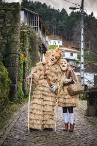 Two caretos pose for a photo during the Lazarim carnival. In Lazarim, northern Portugal, the carnival is celebrated with a tradition known as Entrudo. During this festivity, masks of devils and demons, intricately carved in wood by the village's craftsmen, are prominently featured. The carnival parade through the streets showcases these masks, portraying ancestral scenes of Portuguese culture.