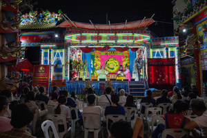 People watch Chinese opera performance during the birthday celebration of Godfather Pung Tao Kong festival in Chiang Mai. The Chinese Opera is a spectacle combining song, dance, acting, poetry and martial arts. The performers wear colorful costumes and elaborate make-up. The Chinese Opera in Thailand is Teochew opera or Chiuchow opera, one of the many variants of its kind, originating from southern China. The traditional Chinese Opera has been a part of Thai culture for centuries, with performances taking place on various occasions in the Thai-Chinese community.