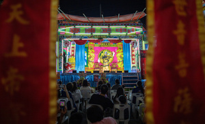 People watch Chinese opera performance during the birthday celebration of Godfather Pung Tao Kong festival in Chiang Mai. The Chinese Opera is a spectacle combining song, dance, acting, poetry and martial arts. The performers wear colorful costumes and elaborate make-up. The Chinese Opera in Thailand is Teochew opera or Chiuchow opera, one of the many variants of its kind, originating from southern China. The traditional Chinese Opera has been a part of Thai culture for centuries, with performances taking place on various occasions in the Thai-Chinese community.