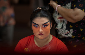 A Thai performer from the "Tie Kia Tong Chia Sung Hiang" Chinese Teochew Opera troupe applies make up at the backstage before going on stage during the birthday celebration of Godfather Pung Tao Kong festival in Chiang Mai. The Chinese Opera is a spectacle combining song, dance, acting, poetry and martial arts. The performers wear colorful costumes and elaborate make-up. The Chinese Opera in Thailand is Teochew opera or Chiuchow opera, one of the many variants of its kind, originating from southern China. The traditional Chinese Opera has been a part of Thai culture for centuries, with performances taking place on various occasions in the Thai-Chinese community.