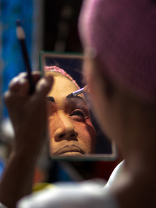 A Thai performer from the "Tie Kia Tong Chia Sung Hiang" Chinese Teochew Opera troupe applies make up backstage before going on stage during the birthday celebration of Godfather Pung Tao Kong festival in Chiang Mai. The Chinese Opera is a spectacle combining song, dance, acting, poetry and martial arts. The performers wear colorful costumes and elaborate make-up. The Chinese Opera in Thailand is Teochew opera or Chiuchow opera, one of the many variants of its kind, originating from southern China. The traditional Chinese Opera has been a part of Thai culture for centuries, with performances taking place on various occasions in the Thai-Chinese community.