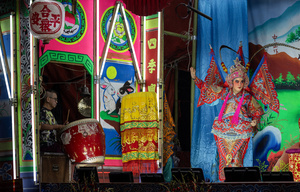 A Thai performer and musician from the "Tie Kia Tong Chia Sung Hiang" Chinese Teochew Opera troupe performs during the birthday celebration of Godfather Pung Tao Kong festival in Chiang Mai. The Chinese Opera is a spectacle combining song, dance, acting, poetry and martial arts. The performers wear colorful costumes and elaborate make-up. The Chinese Opera in Thailand is Teochew opera or Chiuchow opera, one of the many variants of its kind, originating from southern China. The traditional Chinese Opera has been a part of Thai culture for centuries, with performances taking place on various occasions in the Thai-Chinese community.