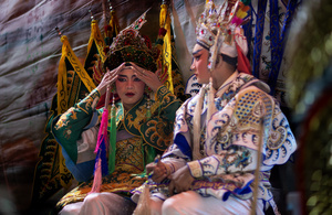 Thai performers from the "Tie Kia Tong Chia Sung Hiang" Chinese Teochew Opera troupe prepare backstage during the birthday celebration of Godfather Pung Tao Kong festival in Chiang Mai. The Chinese Opera is a spectacle combining song, dance, acting, poetry and martial arts. The performers wear colorful costumes and elaborate make-up. The Chinese Opera in Thailand is Teochew opera or Chiuchow opera, one of the many variants of its kind, originating from southern China. The traditional Chinese Opera has been a part of Thai culture for centuries, with performances taking place on various occasions in the Thai-Chinese community.