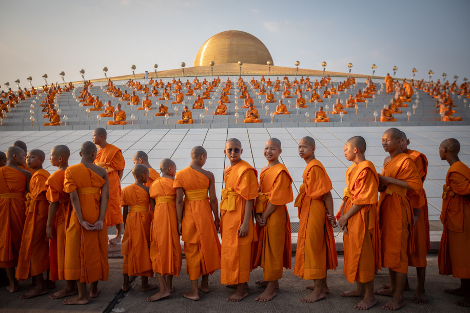 Young monks gather during the yearly ceremony of Makha Bucha at Wat Dhammakaya in the north of Bangkok. Thai people celebrate the Buddhist festival of clockwise circumambulation and Makha Bucha lantern lighting ceremony at Dhammakaya Temple on 'Makha Bucha Day' during the third lunar moon, where around 5000 monks gathered to be ordained by the Buddha and 35000 devotees holding lanterns.