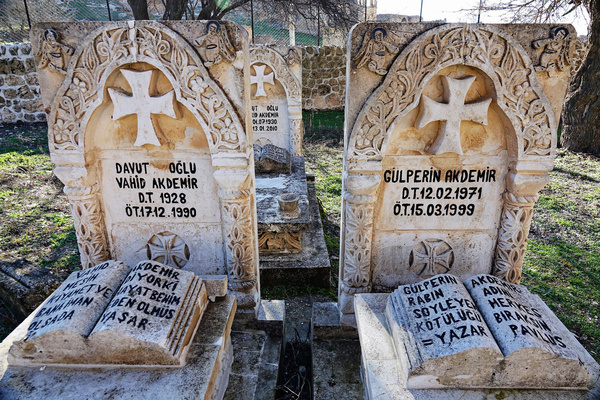 Graves are seen in the garden of Mor Yuhanun Church in Qillit village. The village of Qillit (Dereici) is a historic Christian village near the Savur district of Mardin province in Turkey. There are only 2 Christian families left in Qillit village, which was once home to around 20,000 Christians. The people of the village first started to migrate to different countries during the Ottoman Empire in 1914. After the 1960s, the Christian community was forced to leave their village due to the oppression they faced. The houses left behind by Christian families were vandalised and demolished, and their belongings were stolen. One of the three churches in the village is open for worship, the other two are closed. The village of Qillit has been attracting tourists in recent years. Many tourists go to see the ruined village.