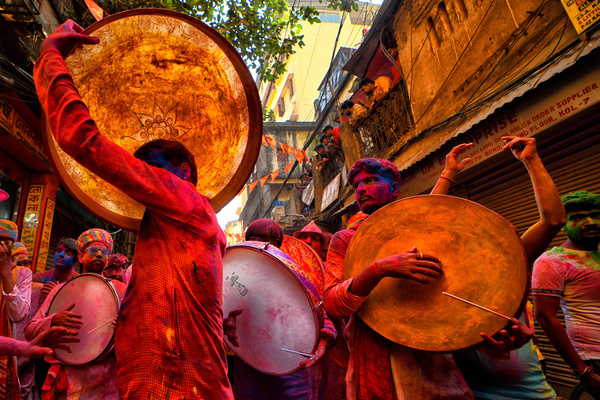 Devotees seen dancing and playing drums during the Holi festival celebration. Holi, also known as the festival of colors, is celebrated to mark the arrival of spring in India.