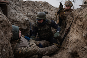 Trainees approach a potentially injured soldier in a training simulating an evacuation mission in the trench organised by the third separate assault brigade in Kyiv region. Ukraine is facing a shortage of ammunition and military personnel. Aside from a tougher mobilisation law is under way, some brigades in the country have chosen a more encouraging approach to recruit people without previous military experience to join the army. The third separate assault brigade offers a 7-day free training course advertises to allow participants to have a taste of military training, enabling them to find their place in the army according to their skills and ability. Participants here are as young as 18 years old. 

When the war between Ukraine and Russia grind on for the second year mark, Ukraine president Volodymyr Zelensky revealed in last December the military wants to mobilise an extra 500,000 people.