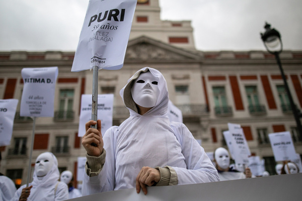 A group of women dressed in white and masks hold placards with the names of different women murdered in Spain due to sexist violence. The "Madrid Forum against violence against women" has called, like every 25th of each month, a rally at Puerta del Sol and at the door of the Ministry of Equality. They have condemned and counted the women murdered by sexist violence.