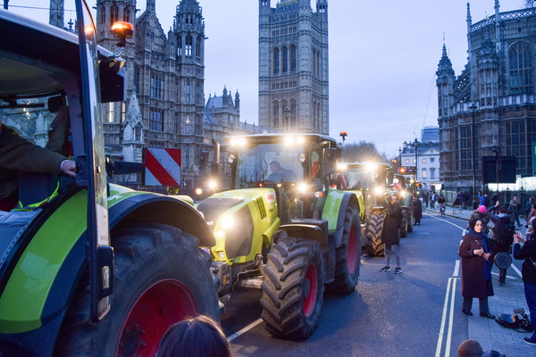 British farmers in tractors stage a protest in Westminster, calling on the government to save British farming, and in opposition to cheap food imports and Net Zero policies. Farmers on tractors protest in Westminster, citing concerns over trade deals that threaten British farming and food security. Tractors gathered in a "go-slow" convoy around Parliament, organized by Save British Farming and Fairness for Farmers of Kent, with around 50 to 100 tractors expected. Several hundred people joined, accompanied by six tractors sounding their horns at College Green around 6:30 pm on Monday.
