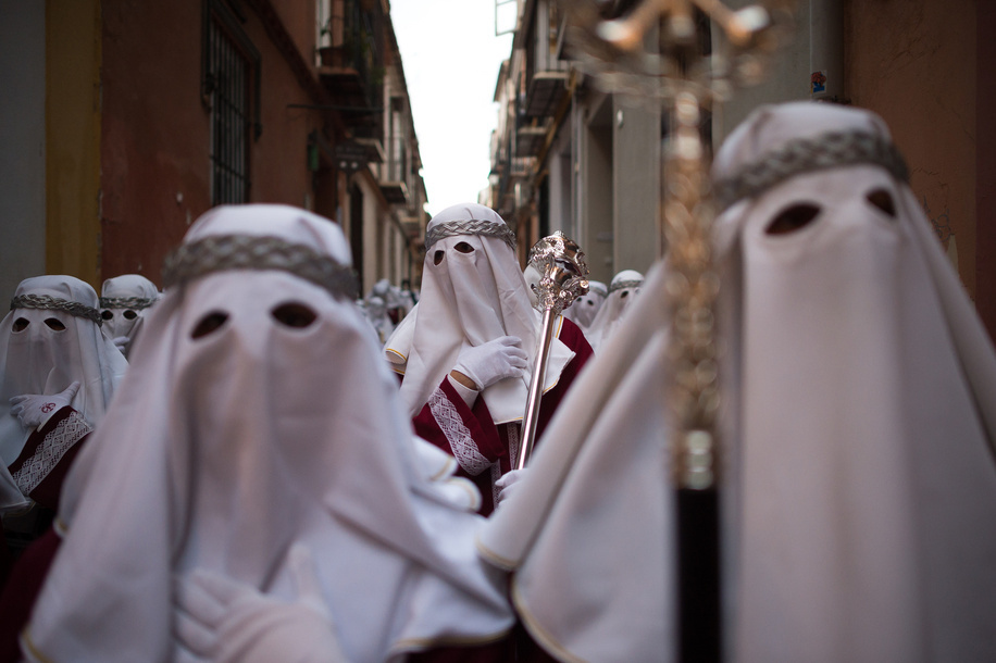 A penitent of 'Gitanos' brotherhood is seen holding a longe pole as he takes part in a procession during the Holy Monday, to mark the Holy Week celebrations. Thousands of worshippers wait to see the processions with the statues of Christ and the Virgin Mary as part of the traditional Holy Week celebrations. In Andalusia, Easter brings together thousands of people from all over the world and it's considered one of the most important religious and cultural events of the year.