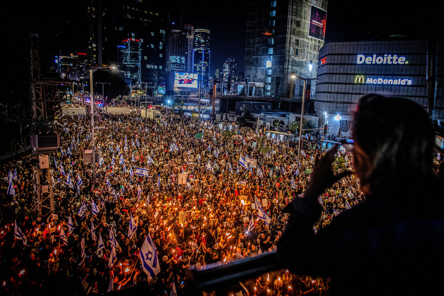 Protestors hold torches during a protest in Tel Aviv. On Saturday, tens of thousands of demonstrators flooded the streets of Israel, rallying against the incumbent government under Prime Minister Benjamin Netanyahu and calling for negotiations to secure the release of hostages held by Hamas. This marks the largest protest since the onset of the Hamas-Israel conflict on October 7th.