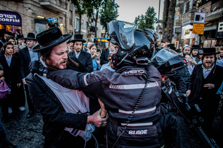 An Israeli police officer pushes back a man during a protest. Dozens of protesters from the Brothers in Arms movement staged a demonstration inside Jerusalem's ultra-Orthodox Mea Shearim neighborhood, calling for the community to be drafted to the Israel Defense Forces (IDF), Sunday had been the deadline for the government to come up with legislation to resolve the issue but Netanyahu filed a last-minute application to the Supreme Court for a 30-day moratorium.