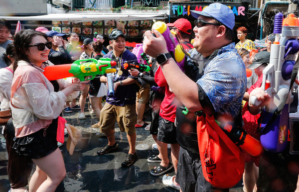 Tourists use water gun toys as they participate in a water fight during the Songkran Festival celebration at Khaosan Road in Bangkok. The Songkran festival, also known as the water festival, marks the start of Thailand's traditional New Year and is believed to wash away bad luck.