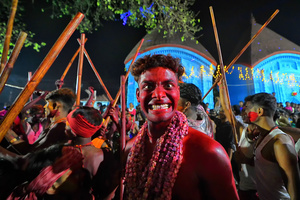 A Hindu devotee with his red colored face poses for a photo during the annual Gajan Festival. Gajan is a Hindu festival celebrated mostly in the rural part of West Bengal. The festival is related to Lord Shiva and as per Mythology on the last day of Bengali Calendar (Middle of April) devotees used to worship dead bodies to satisfy Lord Shiva for better rain and harvest. The central theme of this festival is deriving satisfaction through non-sexual pain, devotion and sacrifice.