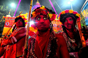 Hindu devotees with their faces and bodies painted with Red color pose for photos during the annual Gajan Festival. Gajan is a Hindu festival celebrated mostly in the rural part of West Bengal. The festival is related to Lord Shiva and as per Mythology on the last day of Bengali Calendar (Middle of April) devotees used to worship dead bodies to satisfy Lord Shiva for better rain and harvest. The central theme of this festival is deriving satisfaction through non-sexual pain, devotion and sacrifice.