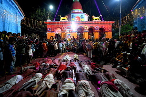 Hindu devotees are seen praying to their almighty before taking part in the annual Gajan Festival at Rudradev Temple of Murshidabad. Gajan is a Hindu festival celebrated mostly in the rural part of West Bengal. The festival is related to Lord Shiva and as per Mythology on the last day of Bengali Calendar (Middle of April) devotees used to worship dead bodies to satisfy Lord Shiva for better rain and harvest. The central theme of this festival is deriving satisfaction through non-sexual pain, devotion and sacrifice.