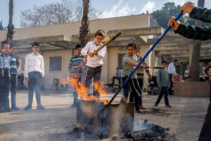 Boys seen burning leaven at a fire pit during the Biur Chametz. During the Biur Chametz, religious Jews fulfill their obligation to inspect their homes for any leaven and eliminate it before the night of Passover. In ultra-Orthodox cities in Israel, fires are set up in major locations in the city for this purpose, where people bring their bread leftovers to burn the leaven. During the seven days of Passover, they are prohibited from eating or possessing any leaven, symbolizing the dough the Israelites did not have time to allow to rise before the Exodus from Egypt. Biur Chametz, also known as 'the burning of the leavened goods,' is a Jewish ceremonial ritual involving the burning of leavened foods (chamets) to mark the start of Passover.