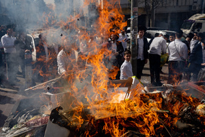 A view of a fire set for burning the leaven during the Biur Chametz. During the Biur Chametz, religious Jews fulfill their obligation to inspect their homes for any leaven and eliminate it before the night of Passover. In ultra-Orthodox cities in Israel, fires are set up in major locations in the city for this purpose, where people bring their bread leftovers to burn the leaven. During the seven days of Passover, they are prohibited from eating or possessing any leaven, symbolizing the dough the Israelites did not have time to allow to rise before the Exodus from Egypt. Biur Chametz, also known as 'the burning of the leavened goods,' is a Jewish ceremonial ritual involving the burning of leavened foods (chamets) to mark the start of Passover.