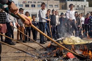 Children seen burning leavened goods at a fire pit during the Biur Chametz. During the Biur Chametz, religious Jews fulfill their obligation to inspect their homes for any leaven and eliminate it before the night of Passover. In ultra-Orthodox cities in Israel, fires are set up in major locations in the city for this purpose, where people bring their bread leftovers to burn the leaven. During the seven days of Passover, they are prohibited from eating or possessing any leaven, symbolizing the dough the Israelites did not have time to allow to rise before the Exodus from Egypt. Biur Chametz, also known as 'the burning of the leavened goods,' is a Jewish ceremonial ritual involving the burning of leavened foods (chamets) to mark the start of Passover.