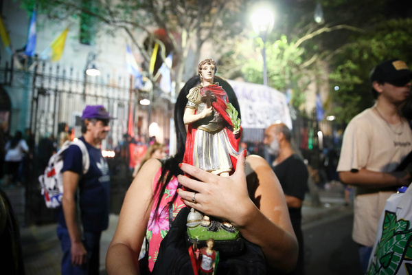A woman holds a figure of San Expedito during the celebration of San Expedito in the Nuestra Señora de Balvanera church. Every April 19, multitudes of faithful gather to give thanks, make requests and pray to the Saint of Just and Urgent Causes.
