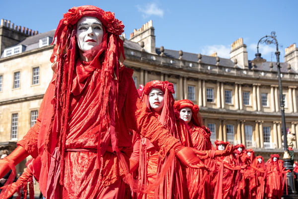 Red Rebels march on the street of Bath during the 'funeral for nature' ceremony. Extinction Rebellion held a 'funeral for nature' march across Bath. Chris Packham and Megan McCubbin (both TV presenters) joined the march along with 400 Red Rebels.