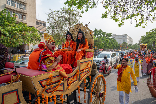 Devotees dressed up as the Hindu gods Ram, Lakshman, and Hanuman sit on a horse cart during the Hanuman Jayanti procession at Connaught Place. Hanuman Jayanti is a Hindu festival that celebrates the birth of Lord Hanuman, one of the most revered deities in Hinduism.