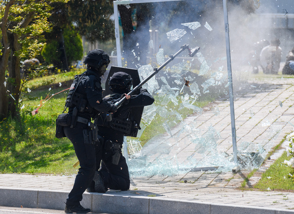 South Korean Police Special Operation Unit members smash a glass door during a terror response drill of the 2024 Chungmu exercise in Seoul. South Korea's Chungmu exercise focuses on actual mobilization training for key resources and recovery training for damage to important facilities in order to master the verification and implementation procedures of wartime preparedness plans.