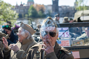 A history enthusiast dressed in World War II US Army uniform smokes before the Convoy of Liberty event in Prague. The Convoy of Liberty commemorates the liberation of the western part of the Czech Republic from Nazi occupation by the US Army, as well as the 79th anniversary of the end of World War II in 1945. Throughout the convoy, individual military history clubs and army forces re-enactors join the routes of Allied armies.