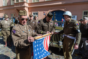 History enthusiasts dressed in a World War II US Army uniform seen holding the American flag during the Convoy of Liberty event in Prague. The Convoy of Liberty commemorates the liberation of the western part of the Czech Republic from Nazi occupation by the US Army, as well as the 79th anniversary of the end of World War II in 1945. Throughout the convoy, individual military history clubs and army forces re-enactors join the routes of Allied armies.