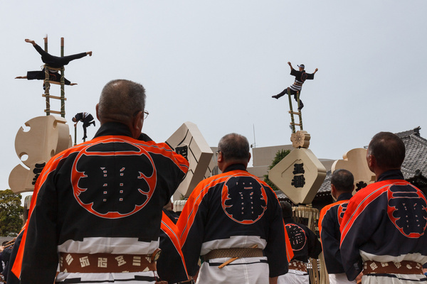 Men wearing festival jackets take part in "hashigo nori" or acrobatic performances atop bamboo ladders during the Edo Firefighter's memorial matsuri at the Yutenji temple. The Tokyo Fire Department and members of the Edo Fireman's Cultural Preservation group organize displays to honor firefighters who died during the Edo (1603–1868) and Showa (1926–1989) periods in Japan.