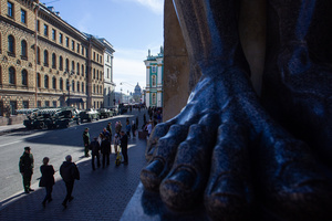 The legs of the sculptural group of Atlanteans with the military equipment of the Russian Armed Forces and the cordon of military personnel seen on Millionnaya Street during the rehearsal of the Victory Parade for May 9 on Palace Square.