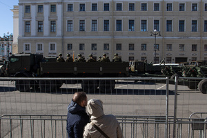 Spectators stand at the fence during a rehearsal for the May 9 Victory Parade on Palace Square.