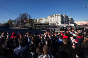 Spectators watch the passage of Russian military equipment of the S-300 anti-aircraft missile system driving along Dvortsovy Proezd during the rehearsal of the Victory Parade for May 9 on Palace Square.