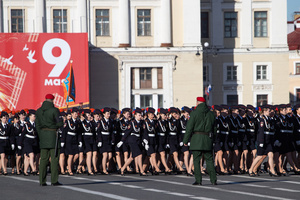 Russian military girls during the rehearsal for the May 9 Victory Parade on Palace Square pass against the background of the arch of the main headquarters.