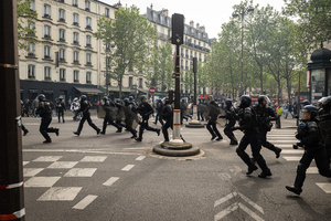 Riot police from the CRS unit of Paris charge towards protestors to disperse them during the labour day demonstration. A day full of clashes between the black-block, anarchists and anti-capitalists groups, with the police became the norm on the celebration of the 1st of May - Labour day in Paris, as demonstrators complaining about president Macron's government and his political and social law changes.