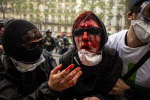 (EDITOR'S NOTE : Image depicts graphic content.) A protestor is hit in the head by a riot police during a charge to disperse the demonstrators. A day full of clashes between the black-block, anarchists and anti-capitalists groups, with the police became the norm on the celebration of the 1st of May - Labour day in Paris, as demonstrators complaining about president Macron's government and his political and social law changes.