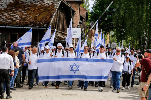 Visitors walk in the March of the Living 2024 at Auschwitz Camp gate. Holocaust survivors and those who survived the October 7th Hamas attack joined the March of the Living alongside a delegation from various countries, including the United States, Canada, Italy, and the United Kingdom. This march, observed on Holocaust Memorial Day in the Jewish calendar (Yom HaShoah), sees thousands of participants walk silently from Auschwitz to Birkenau. The march serves as both an educational experience and a means of remembrance. However, this year's march became highly politicized due to the ongoing Israeli conflict in Occupied Palestine.