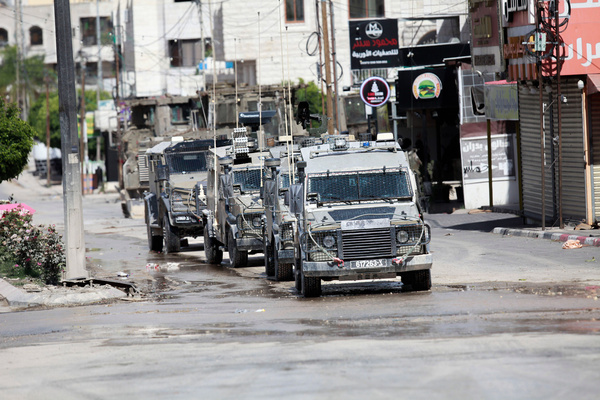 Israeli forces vehicles are seen in Tulkarem during a raid on the occupied West Bank. Israeli army killed five Palestinian militants who were barricaded in a building during a 12-hour siege in Tulkarem. West Bank has seen a surge in violence since the Israel-Hamas war erupted on October 7.