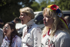 Ukrainian protesters covered with fake blood, cry and shout slogans while Russian ambassador puts flowers at the monument at the cemetery to Red Army soldiers. On Russia's "Victory Day" in Warsaw Russia's Ambassador to Poland, Sergey Andreev and his delegation laid a wreath at the monument at the cemetery to Red Army soldiers who died during World War II. During the ceremony Ukrainian activists tried to disturb the event. May 9th, known as "Victory Day" in Russia, is a holiday commemorating the Soviet victory over Nazi Germany in 1945.